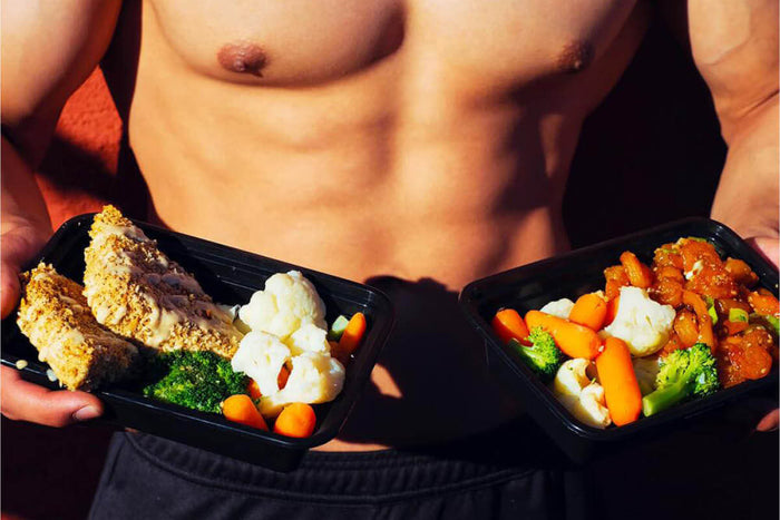 Gym goer holding healthy takeout foods