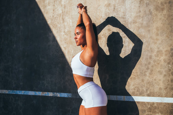 Woman stretching arms in Gym gear