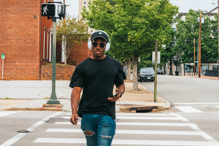 Man walking listening to podcast in the street 