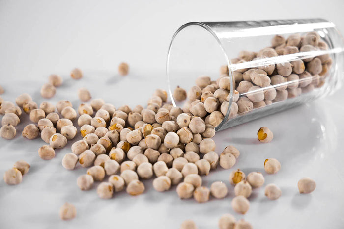 Vegan protein nuts falling out a glass