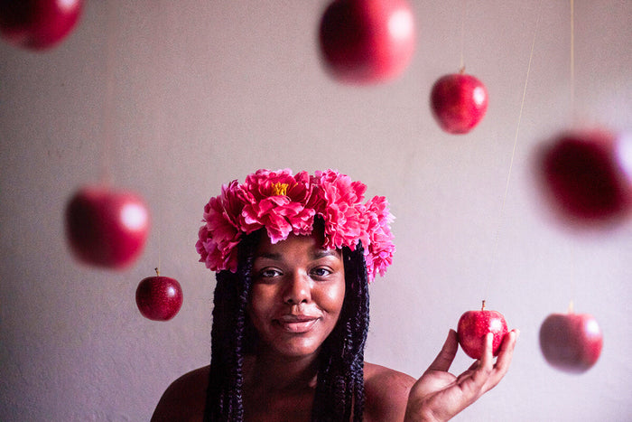 Woman posing with healthy apples falling 