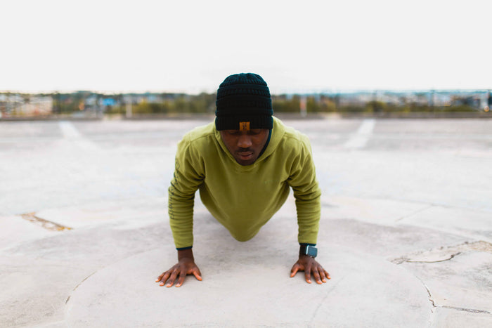 Man doing 30 day burpee challenge in urban area