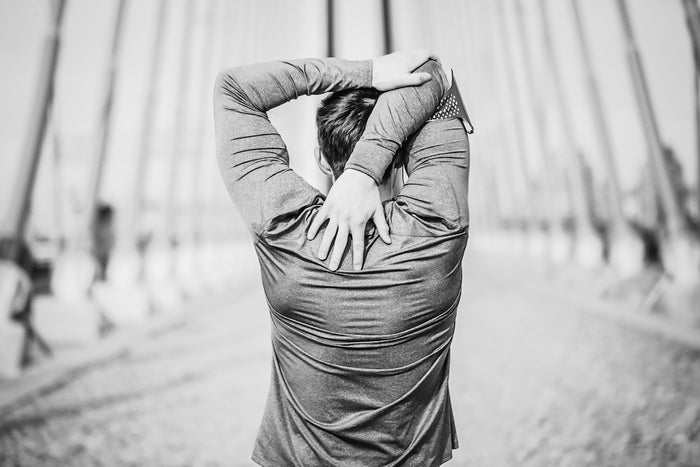 Man stretching arms behind his back 
