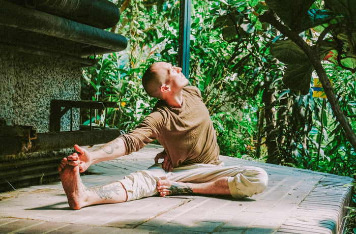 Man touching his toes for exercise from zoom fatigue
