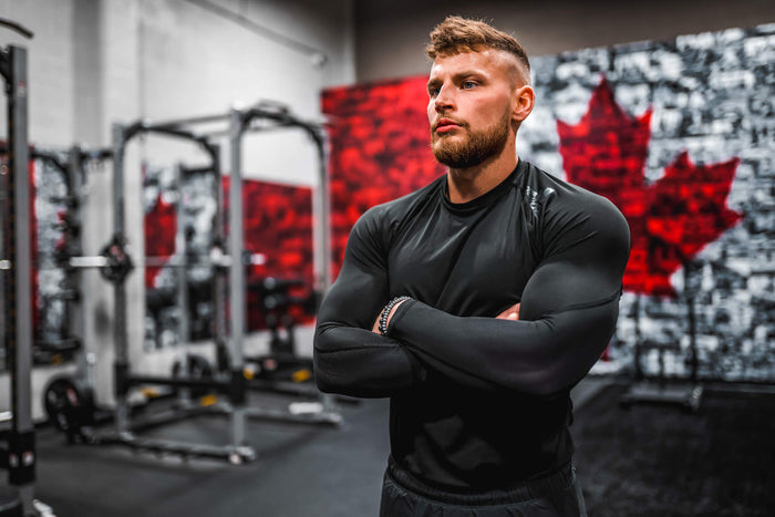 Man standing with arms cross in Canada gym 