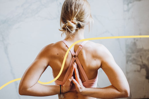 Woman stretching arms behind back to relieve tension 