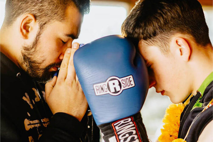 Coach and student with boxing gloves on 