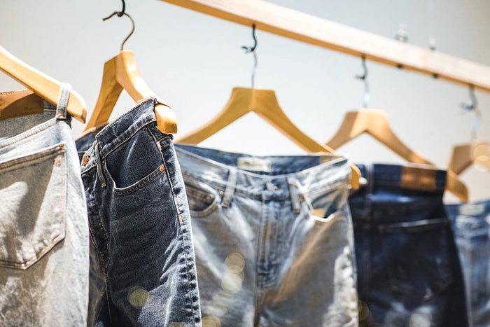 Second hand jeans on clothing rail