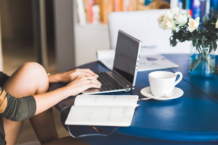 Woman working from dining table