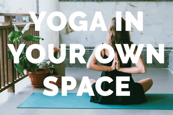 Woman stretching arms behind her back for yoga at home