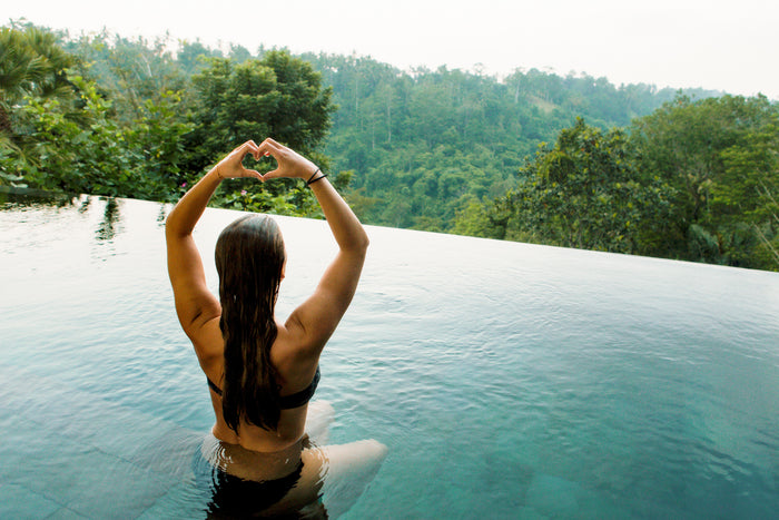 Woman in pool at wellness retreat destination 