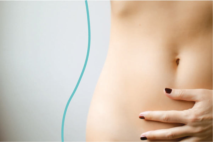 Woman holding her gut: gut health 101