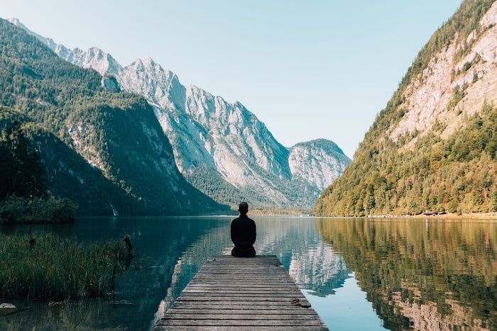 Man sitting on pier mindfulness