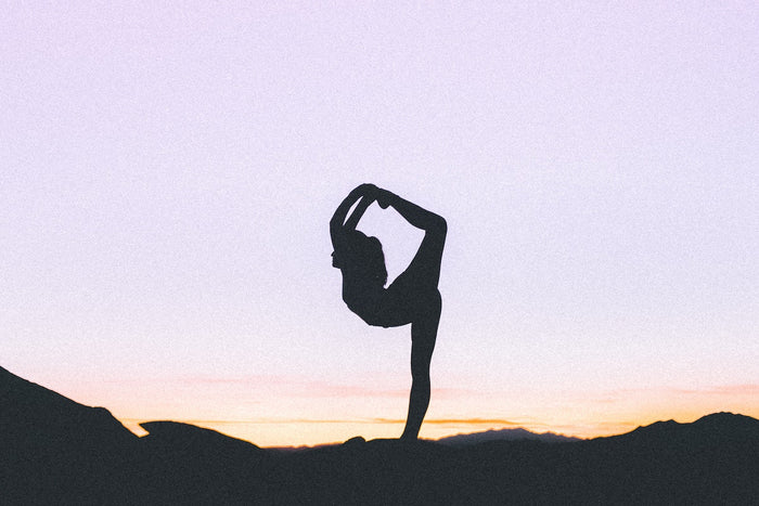 Beginner yoga pose in sunset 