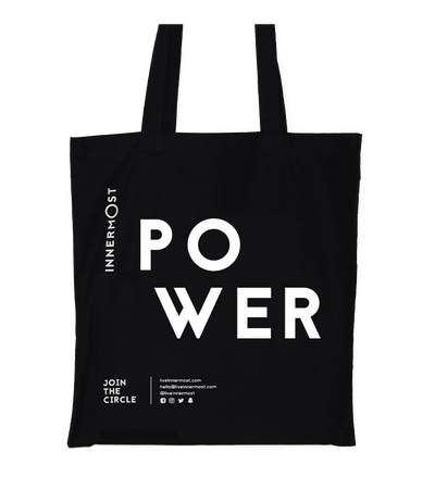 Innermost black cotton tote bag with POWER printed on it