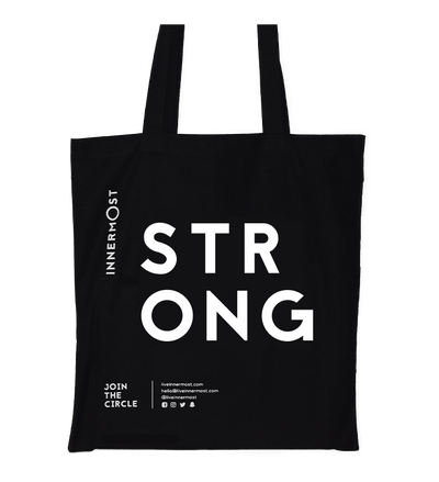 Innermost black cotton tote bag with STRONG printed on it