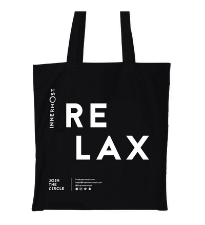 Innermost black cotton tote bag with RELAX printed on it