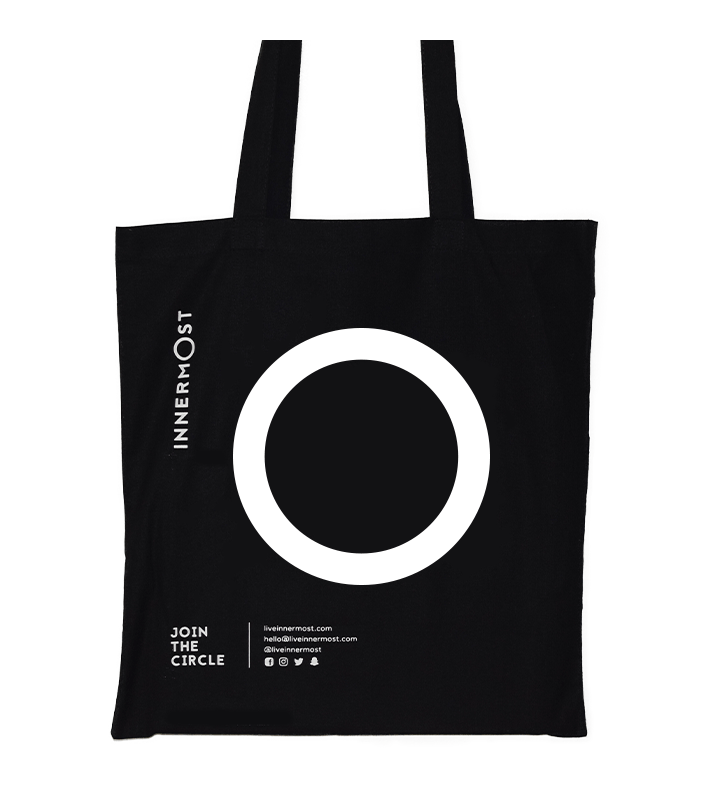 Innermost black cotton tote bag with a large O printed on it